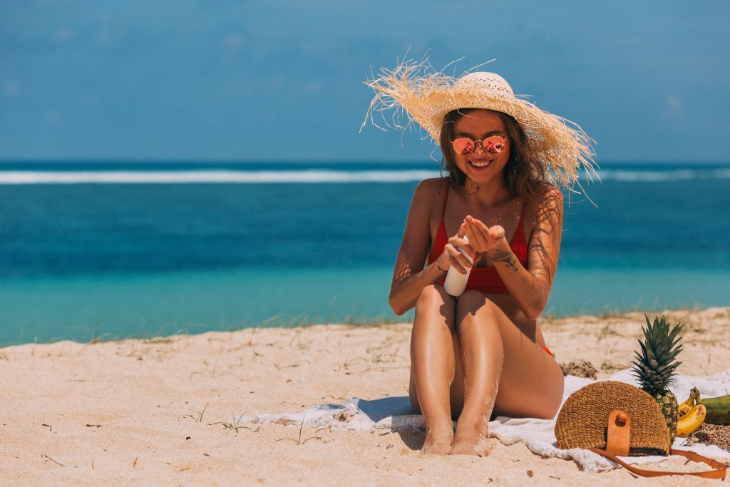 Photo by Mikhail Nilov: https://www.pexels.com/photo/a-woman-in-the-beach-using-a-sun-screen-product-8157581/